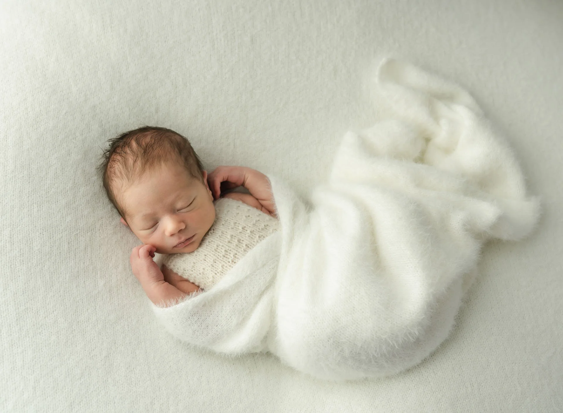 Peaceful wrapped baby portrait captured in Christchurch studio