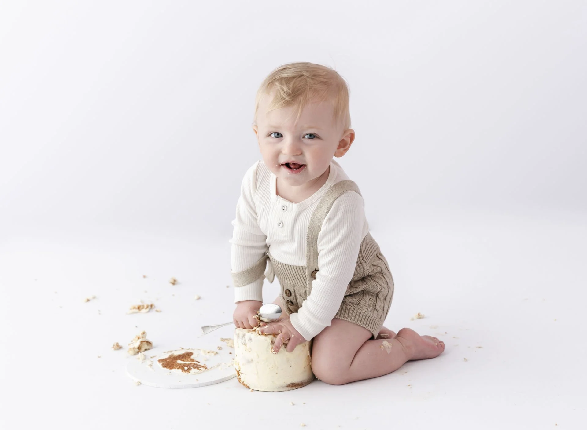 Baby boy smashing cake during celebration milestone session at Eastwood Studios in Christchurch