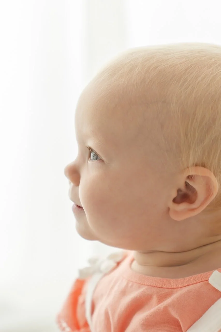 Sweet baby girl close up portrait captured at professional baby sitter session in Canterbury studio