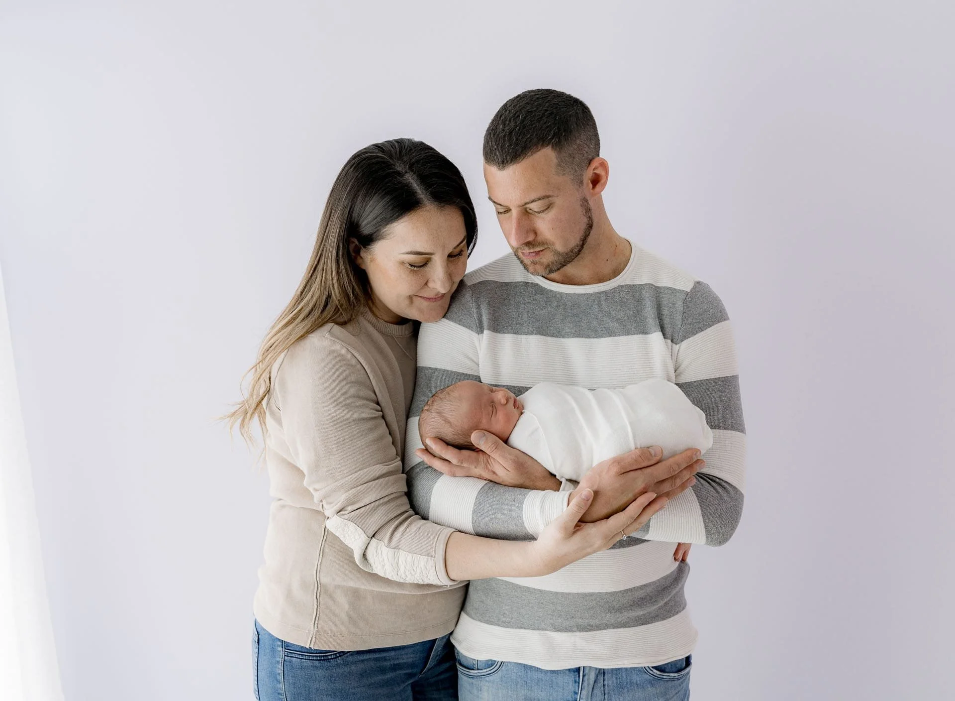 New parents holding their newborn baby during Christchurch photography session