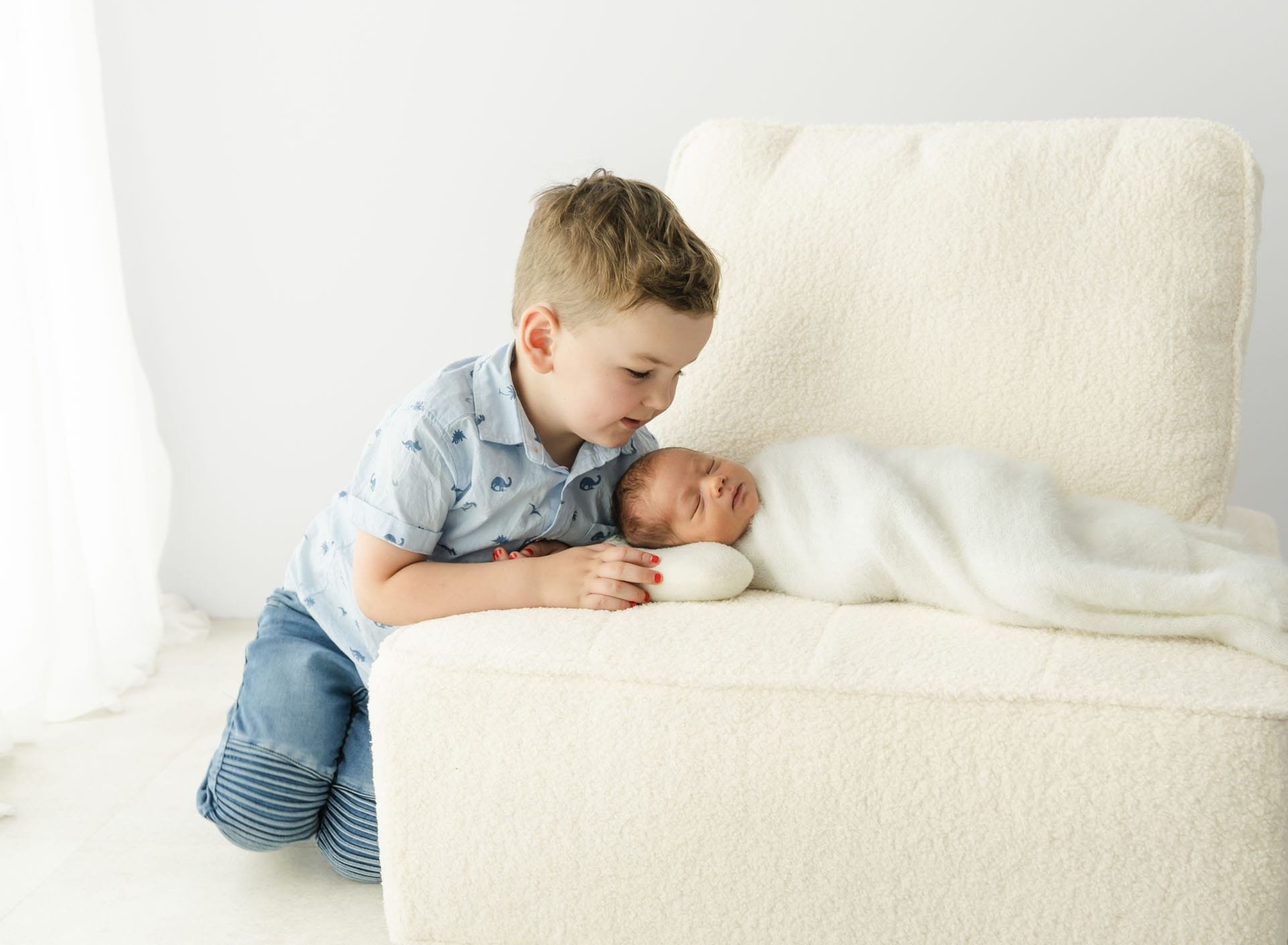 Sibling and wrapped newborn baby during Christchurch newborn photography session