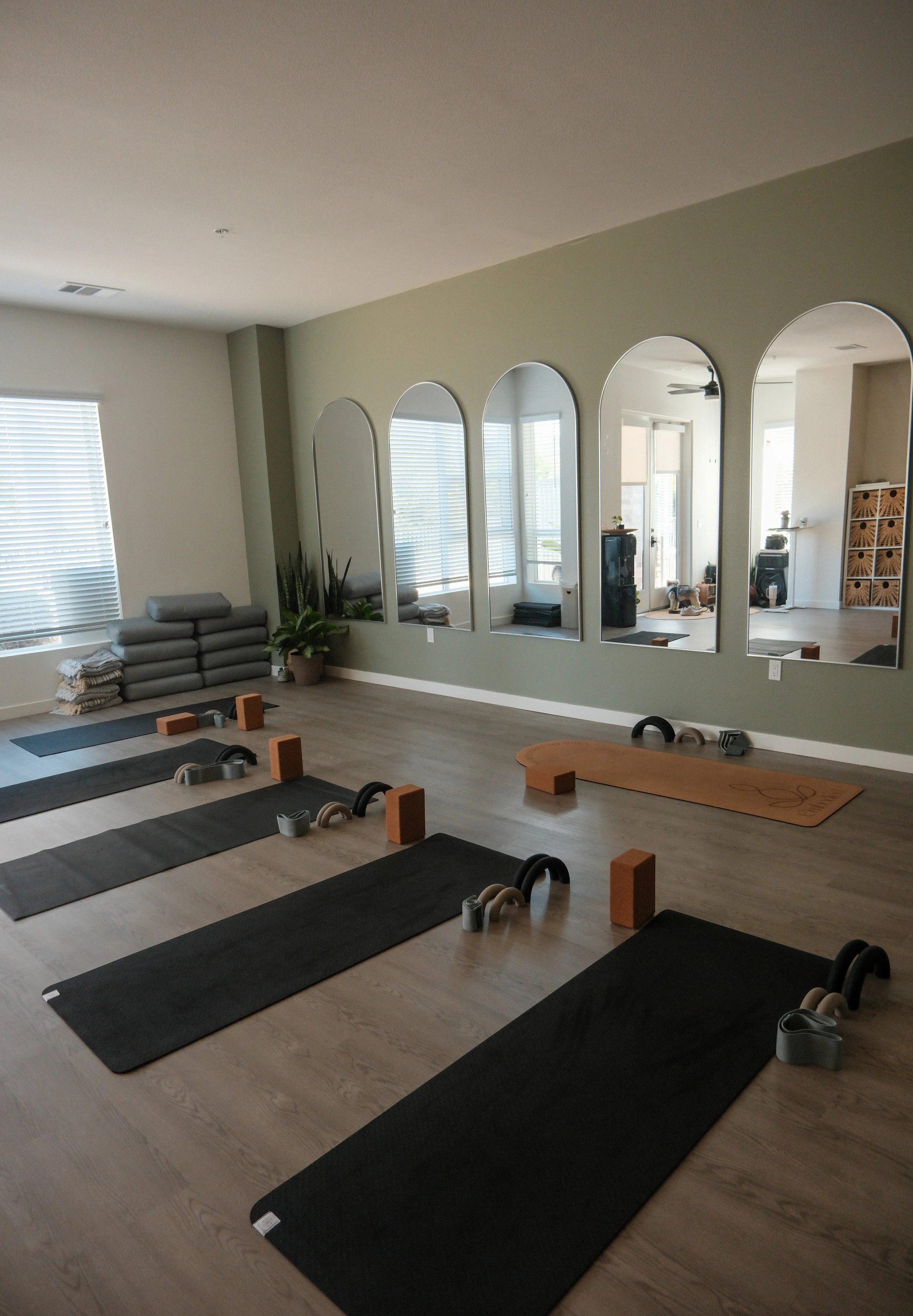 Mats, weights and yoga blocks set up in yoga studio