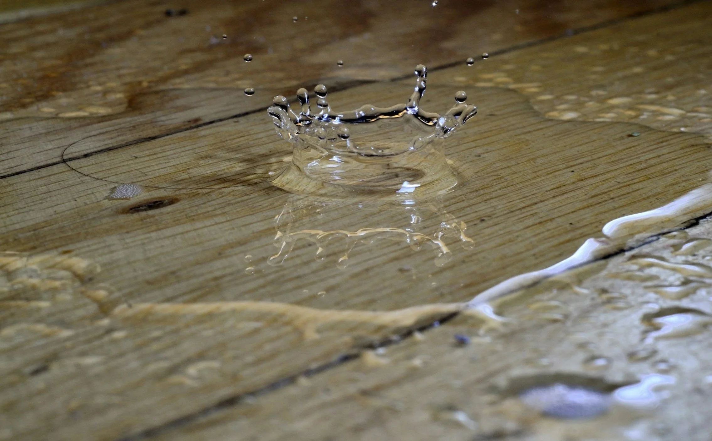 A splash of water on a wooden floor.