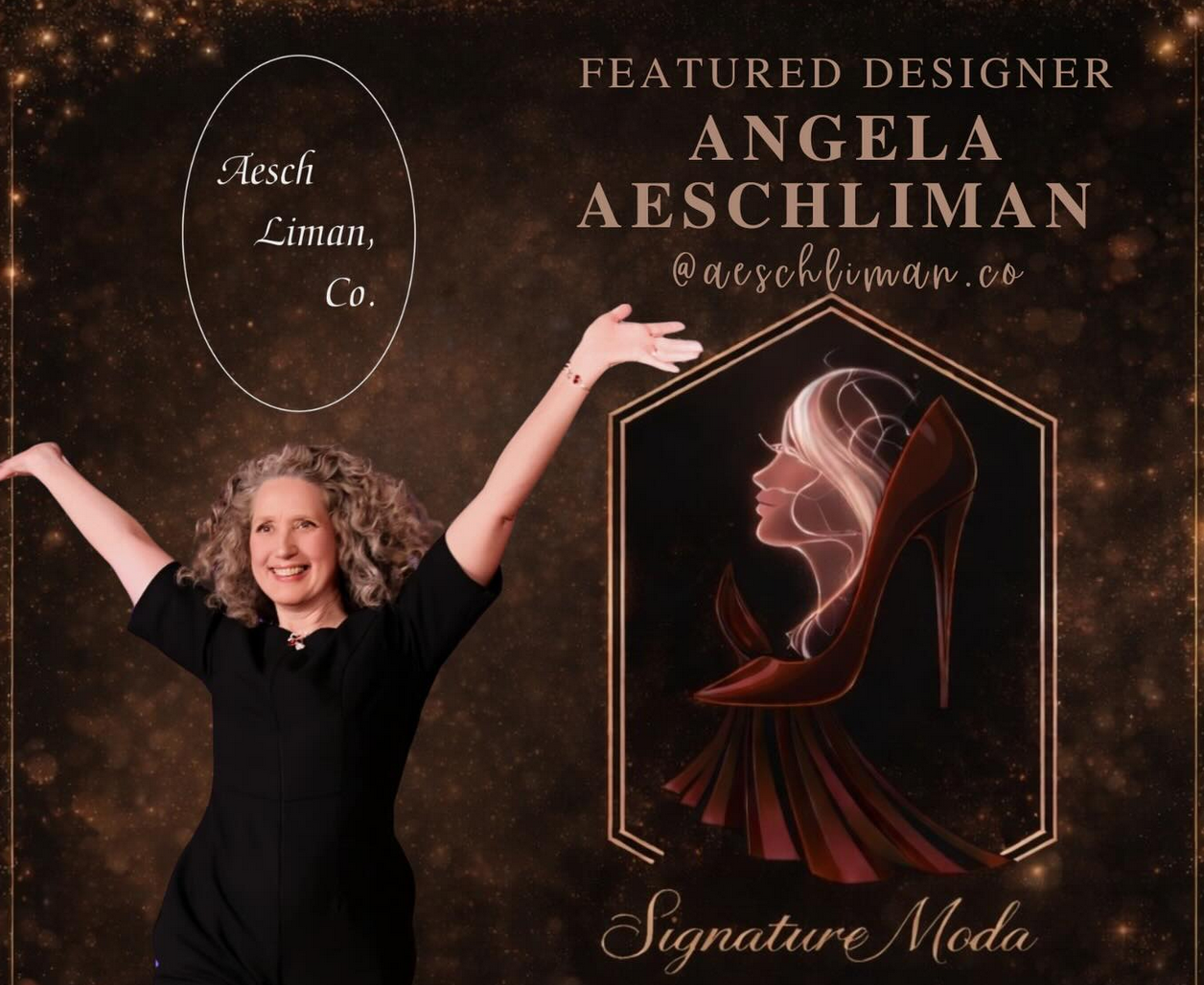 A woman with curly blonde hair smiling and raising her arms in front of a designer promotional display. The display features text about designer Angela Aeschliman, her Instagram handle @aeschliman.co, and a graphic of a woman's profile inside a high-heeled shoe.