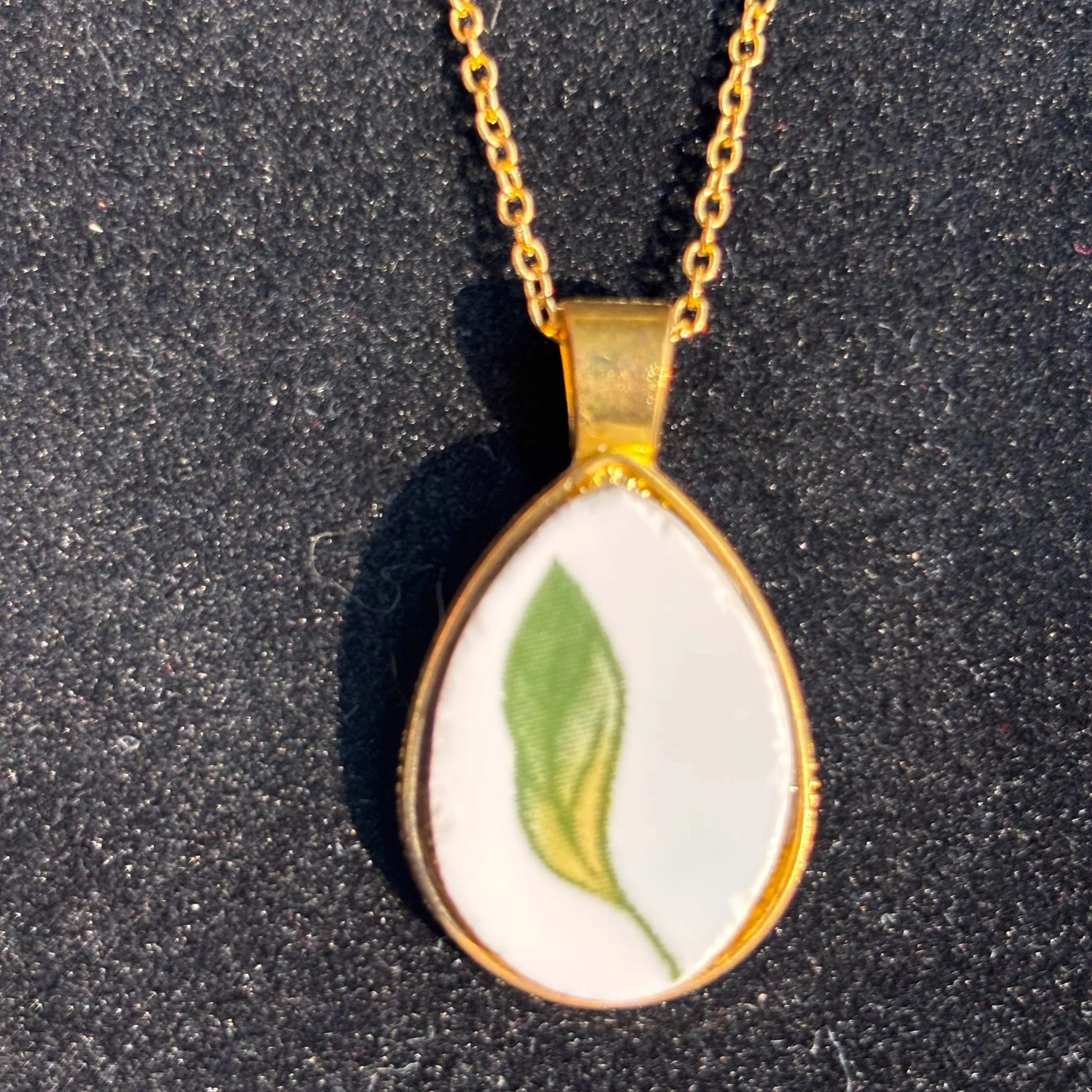 Gold Teardrop Pendant with Porcelain Leaf Design