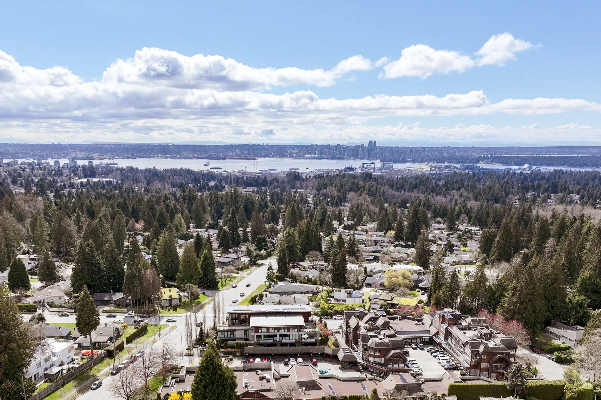 Aerial view of Upper Delbrook, North Vancouver, with Burrard Inlet and downtown Vancouver in the background