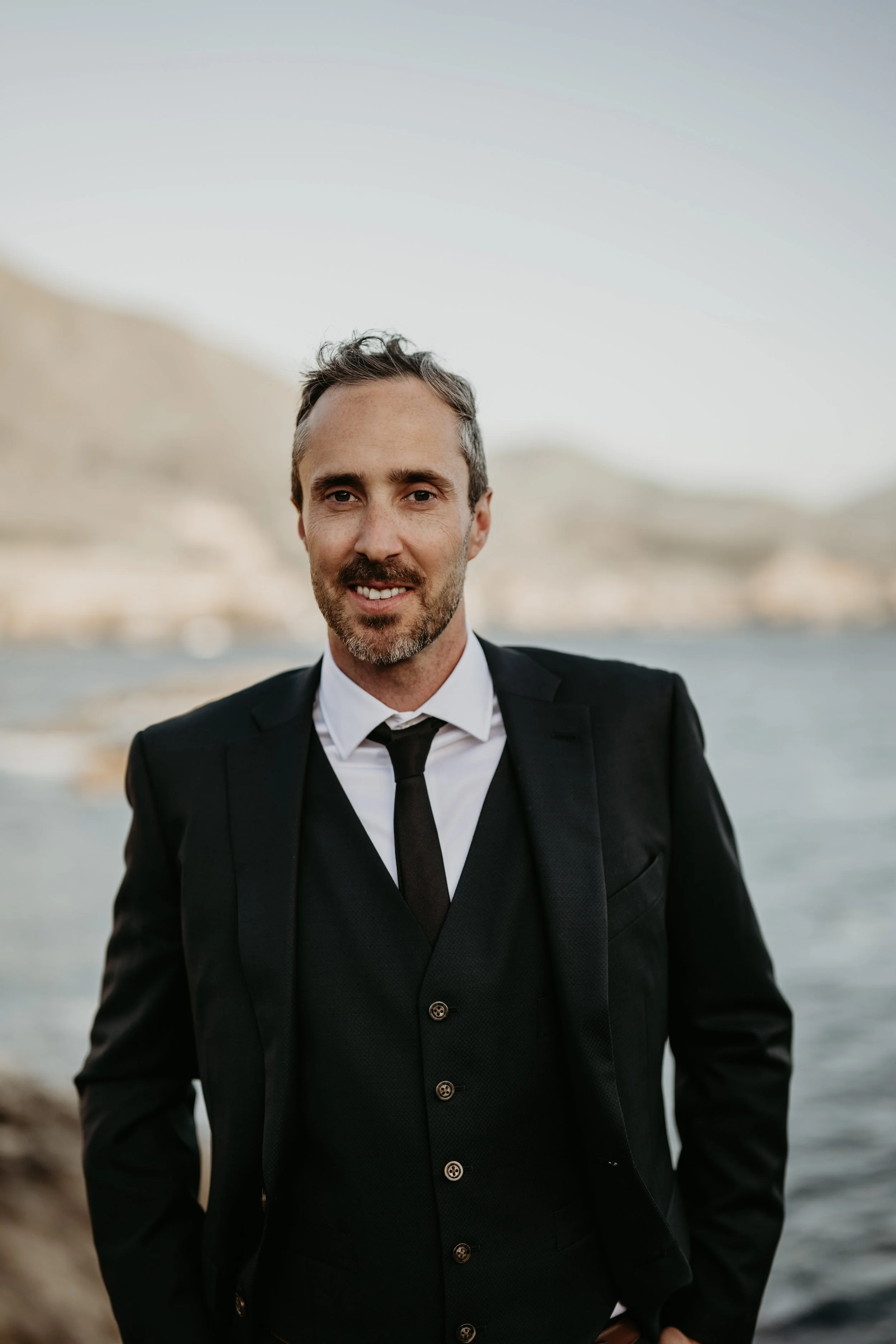 Matt Council, North Shore real estate advisor, smiling outdoors by the water