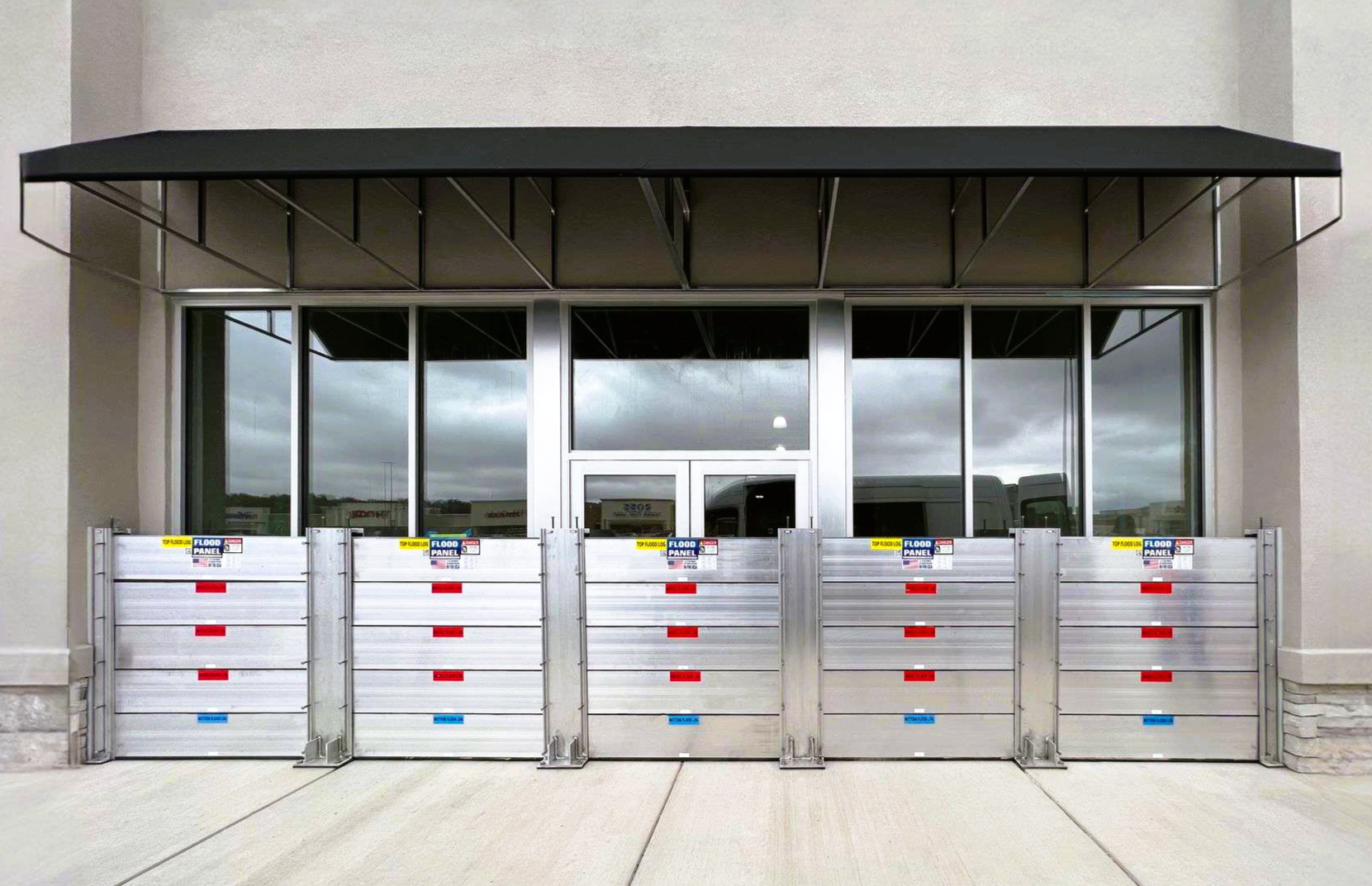 Deployable flood barrier systems installed at commercial building for flood protection deployment.