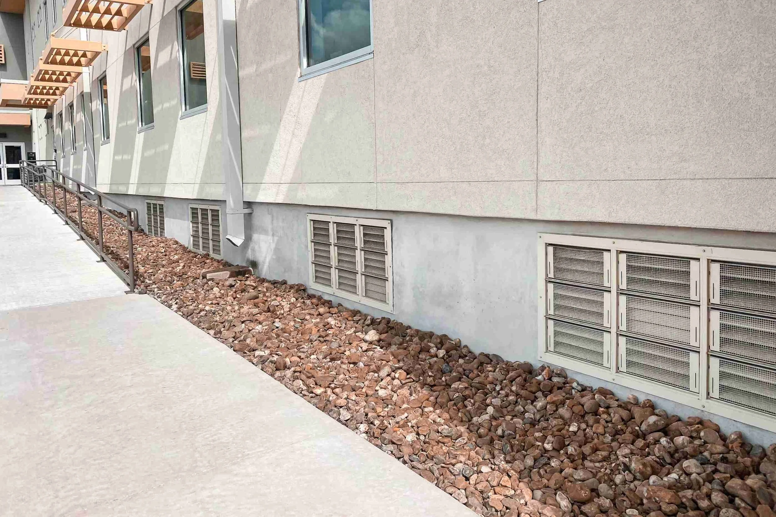 FEMA-compliant flood vent systems installed in commercial foundation wall for hydrostatic pressure relief.