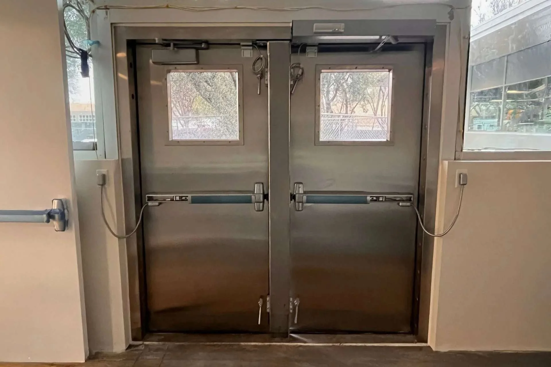 Interior flood-rated double door system installed within commercial facility for compartmentalized flood protection.