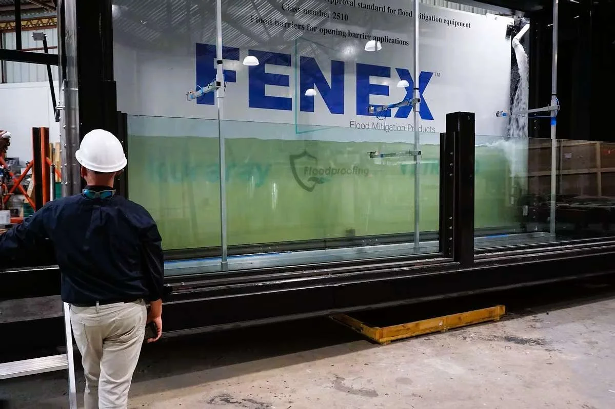 Flood-resistant glass panel undergoing performance testing at manufacturing facility for code-compliant flood protection