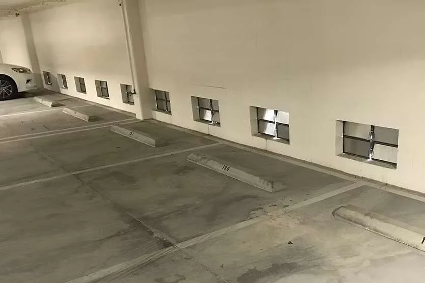 Flood vents installed in enclosed parking structure to equalize hydrostatic pressure during flood events