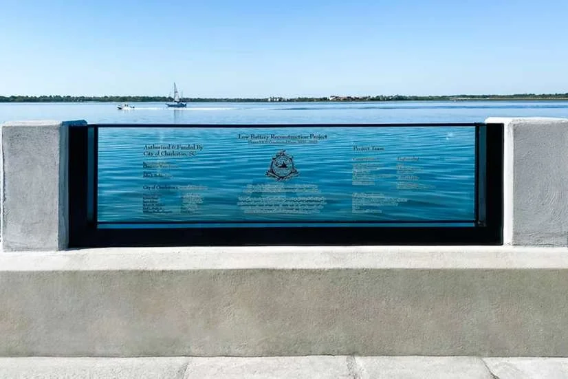 Engineered flood-resistant glass wall system installed along waterfront promenade for perimeter flood protection