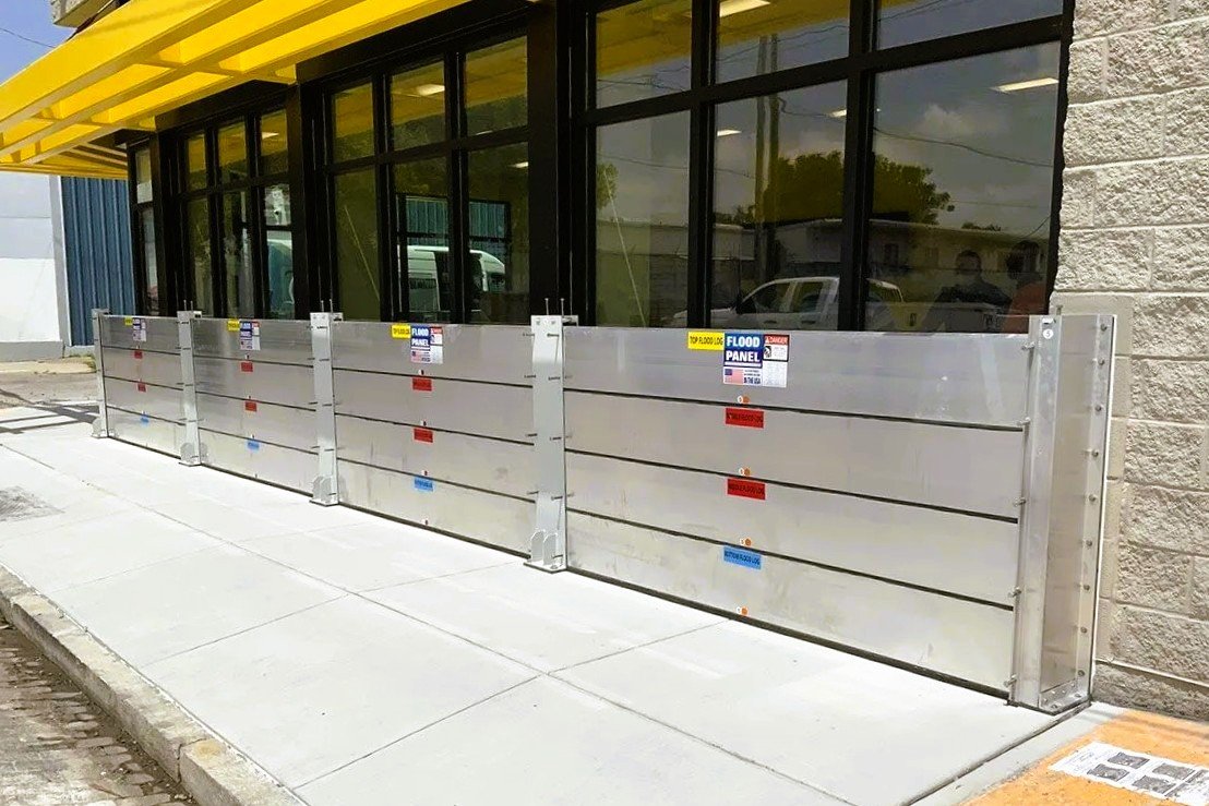 Commercial building protected by aluminum flood barrier system engineered for code compliance and long-term performance