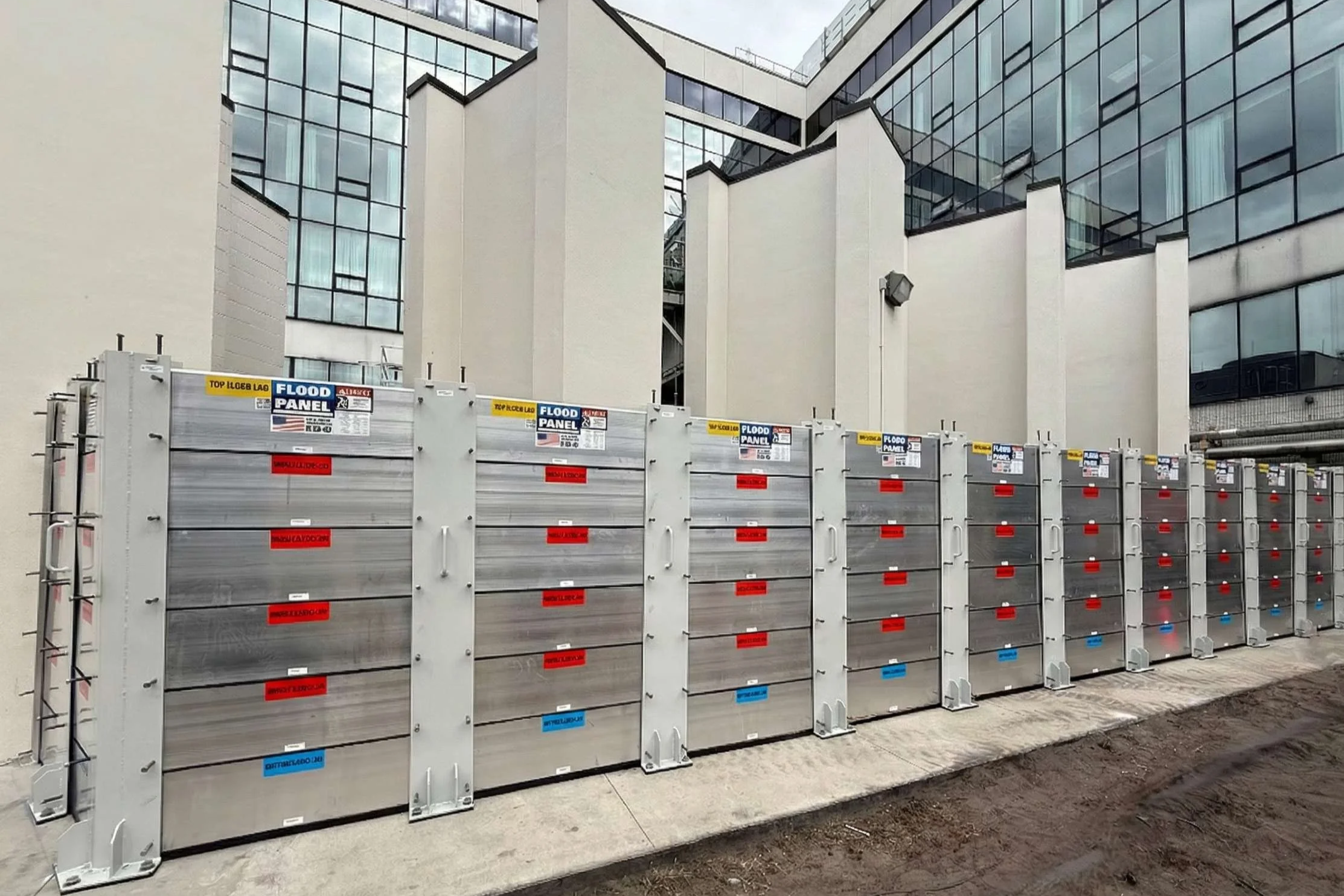 Hospital facility protected by engineered flood barrier systems to maintain critical healthcare operations during flooding