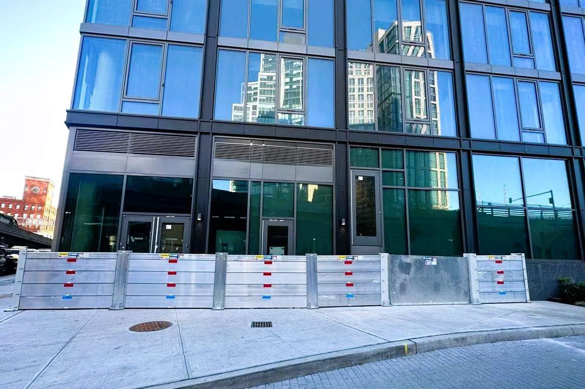 Mixed-use residential and commercial building designed for integrated flood protection and ground-level resilience