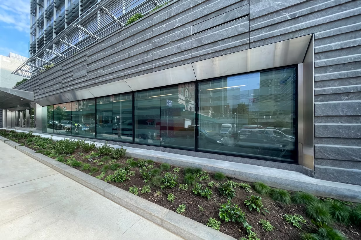 Impact-rated flood-resistant glass system installed along commercial waterfront building.