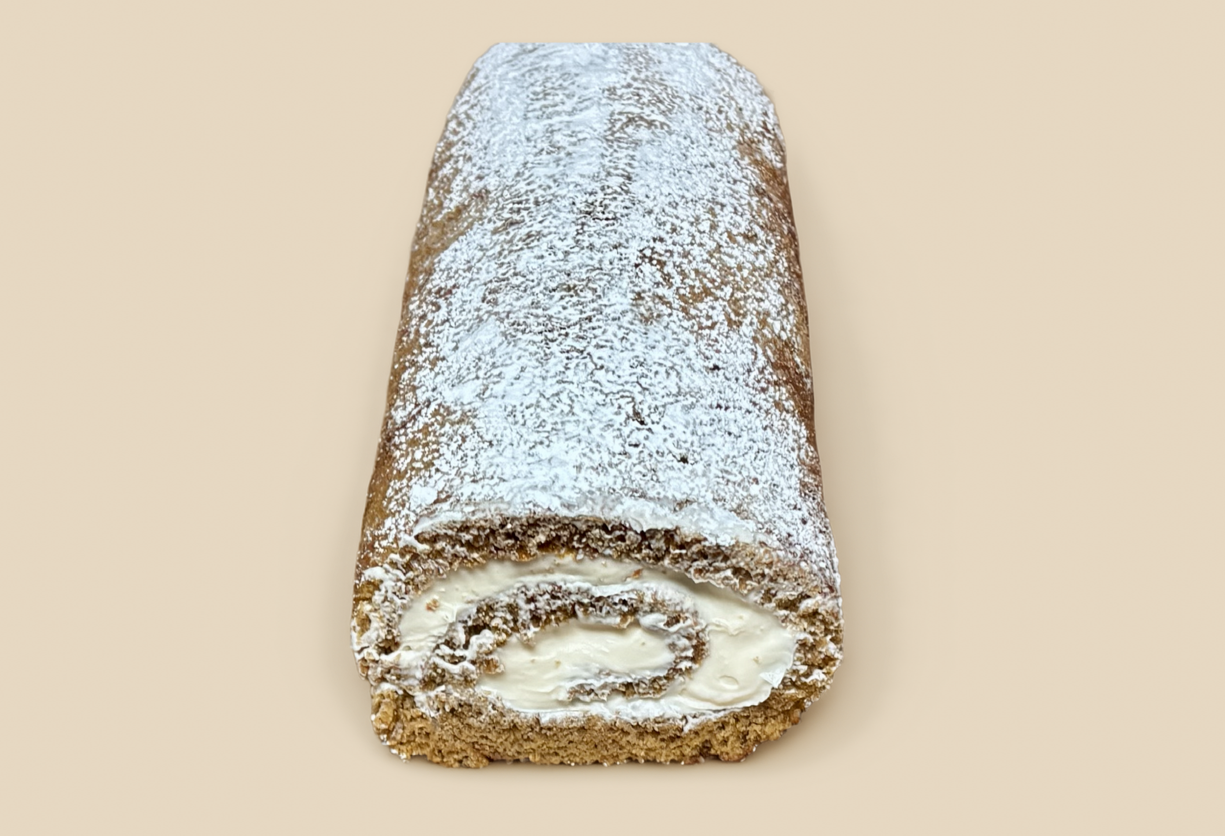 Pumpkin roll filled with cream cheese frosting and dusting of powder sugar