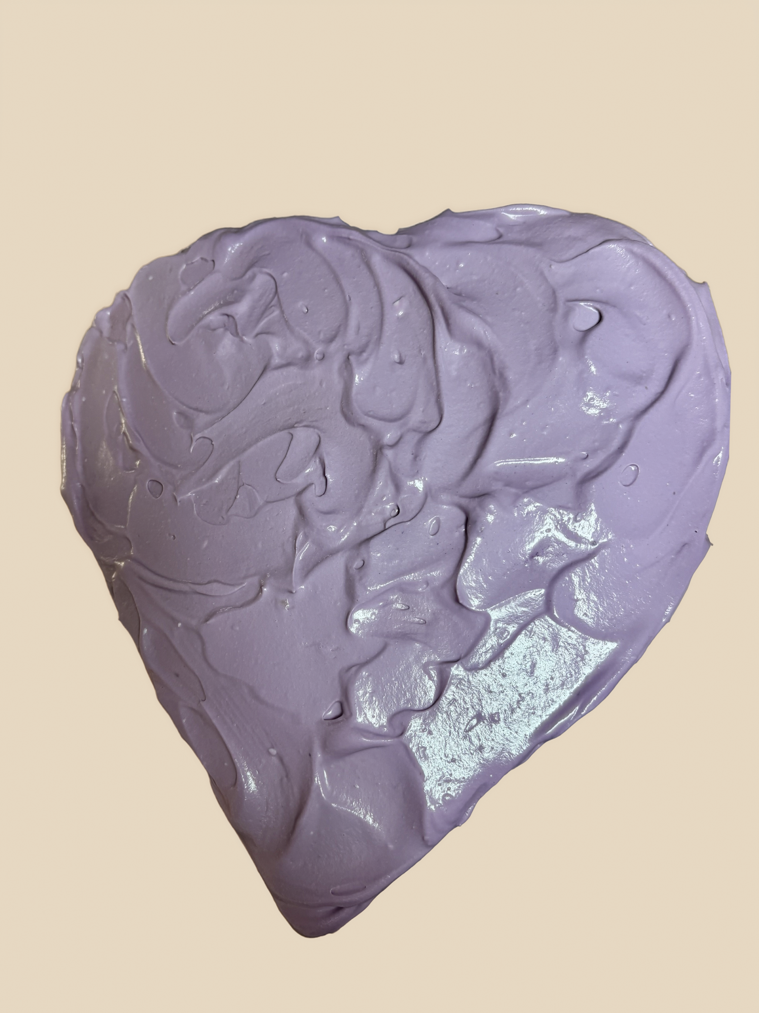 Two layered heart shaped ube cake covered in ube cream cheese frosting, and filled with ube halaya. 