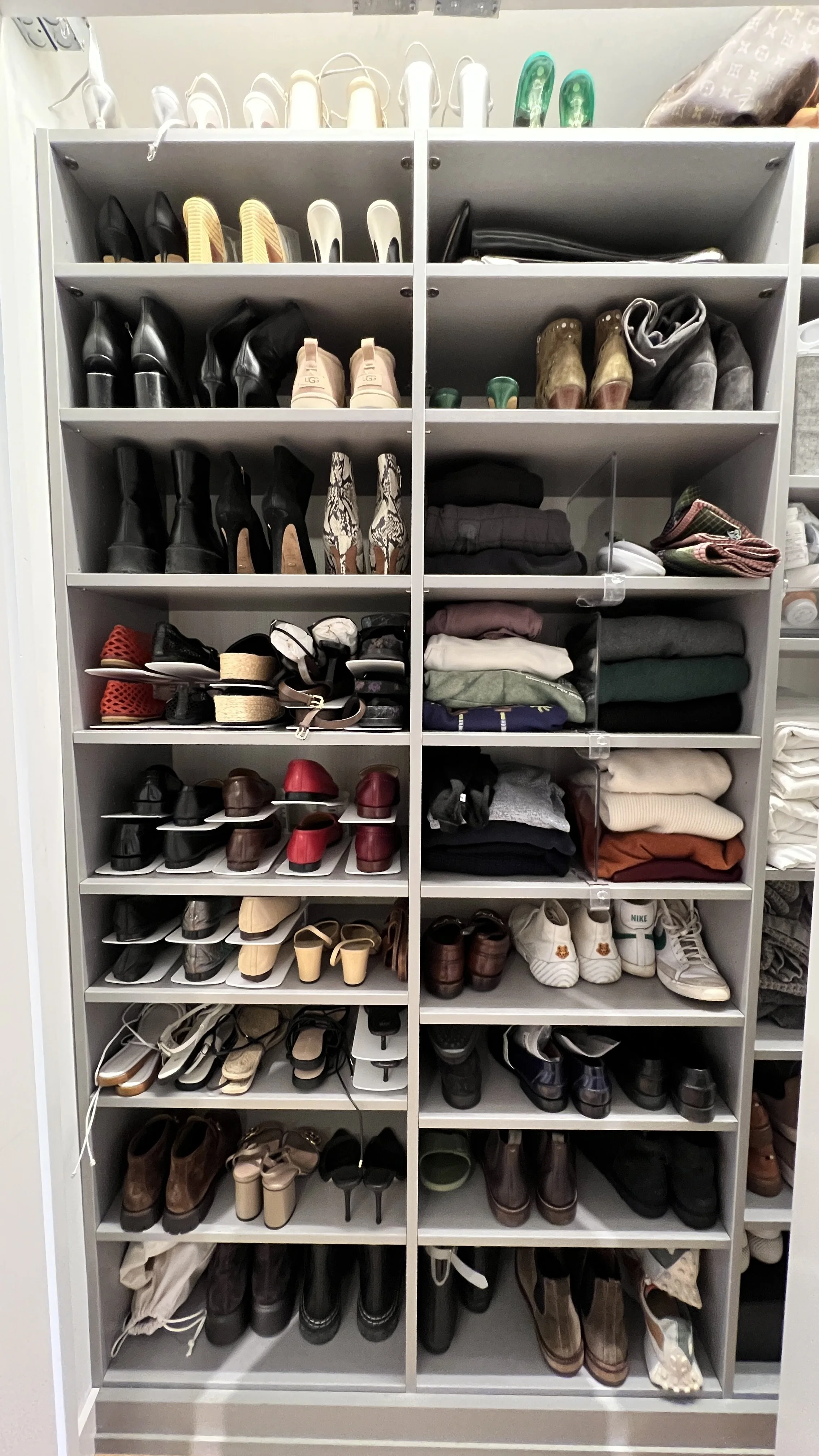 A photo from a closet organizing and stylist session shows shows a tidy and curated shoe closet filled with various pairs of shoes, including sandals, boots, heels, sneakers, and dress shoes, organized on multiple shelves.