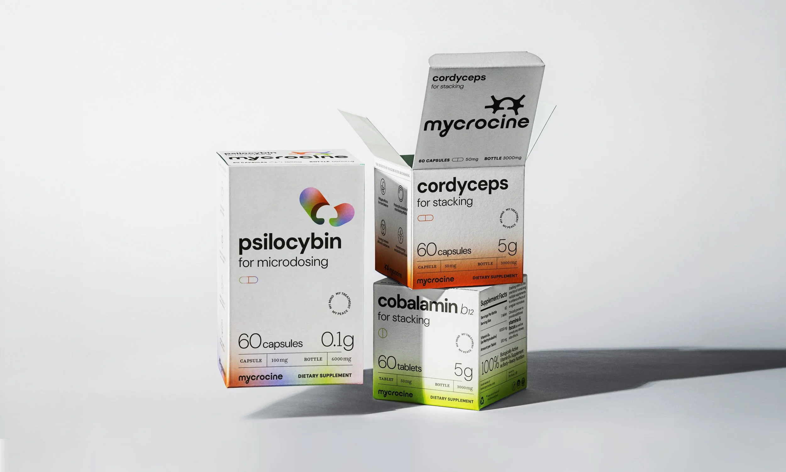 Three boxes of dietary supplements, including psilocybin, cordyceps, and cobalamin, arranged on a plain surface.