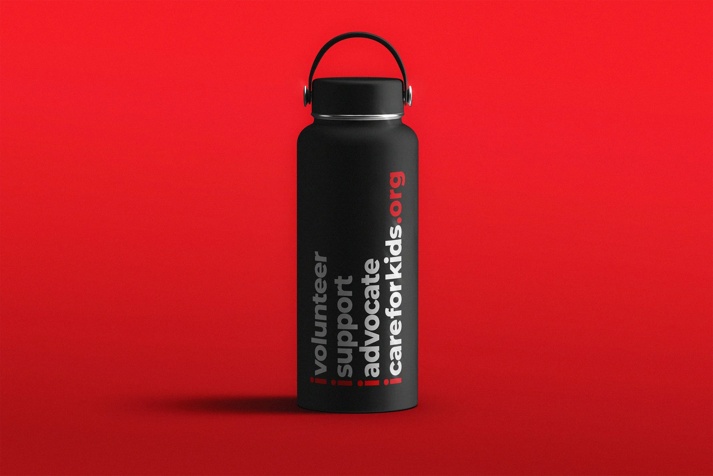 A black insulated water bottle with red and white text on it, displayed against a bright red background.