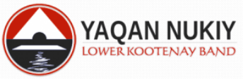 Logo of Yaqan Nukiy Lower Kootenay Band, featuring a red circle with a black and white design of a mountain, water, and a sky.