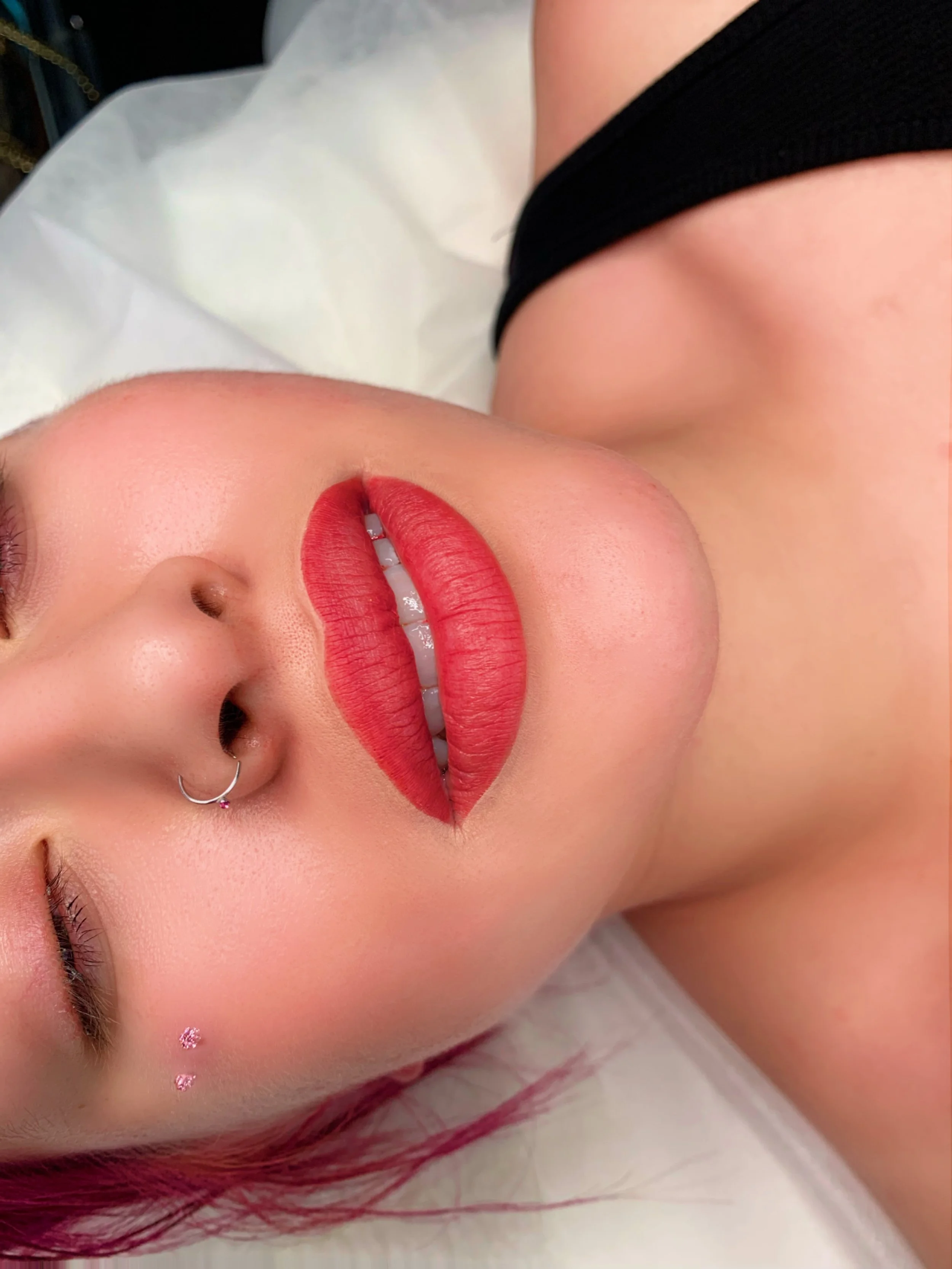 Lip blushing permanent makeup result with soft pink, naturally enhanced lips.