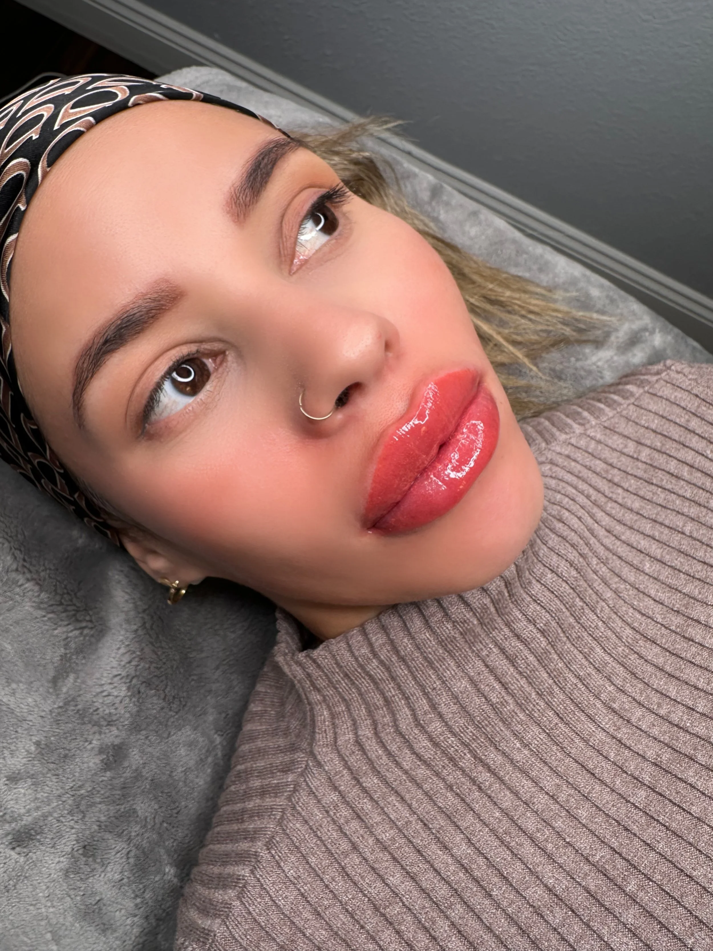 Lip blushing permanent makeup result with soft pink, naturally enhanced lips.