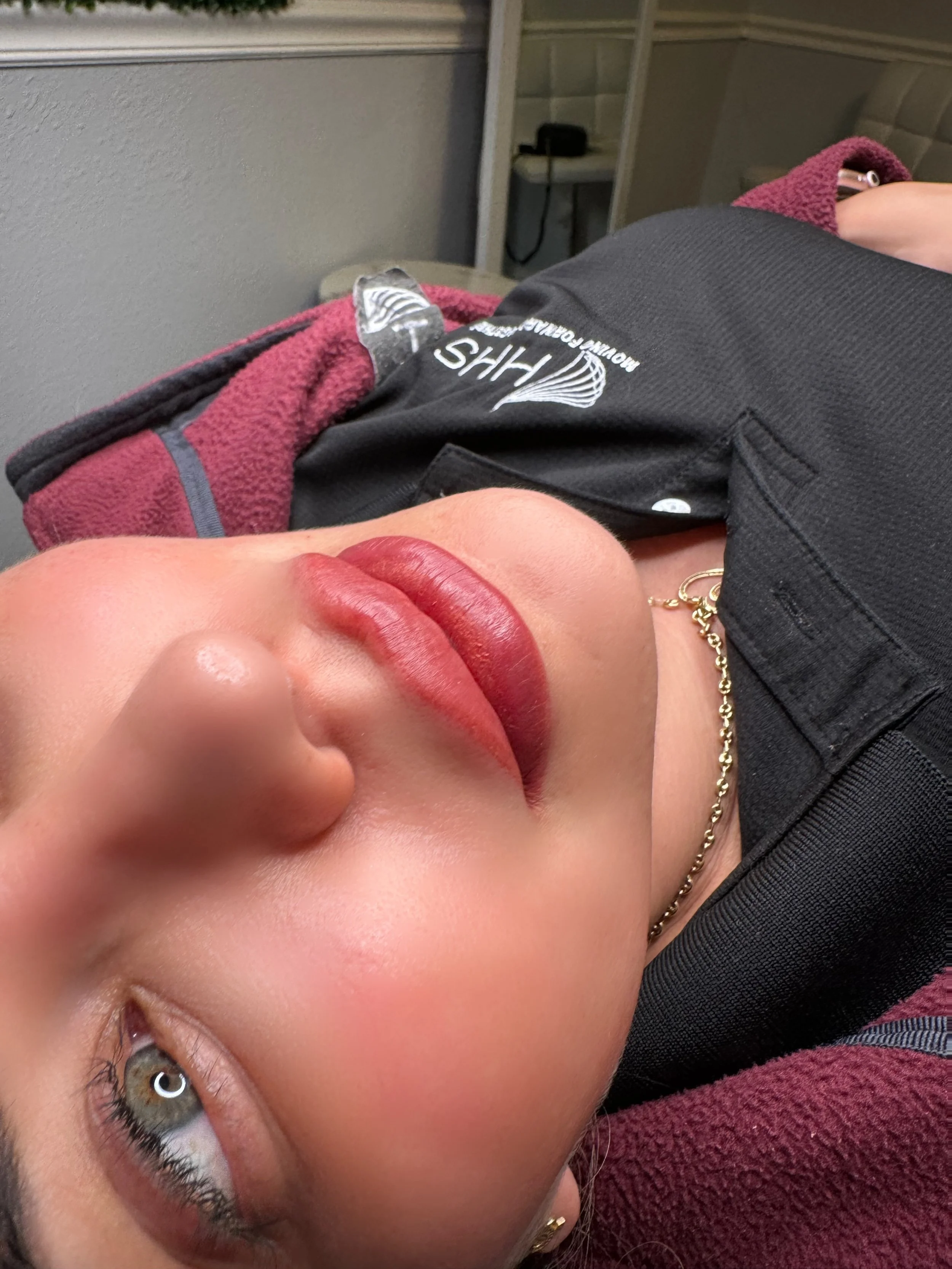 Lip blushing permanent makeup result with soft pink, naturally enhanced lips.