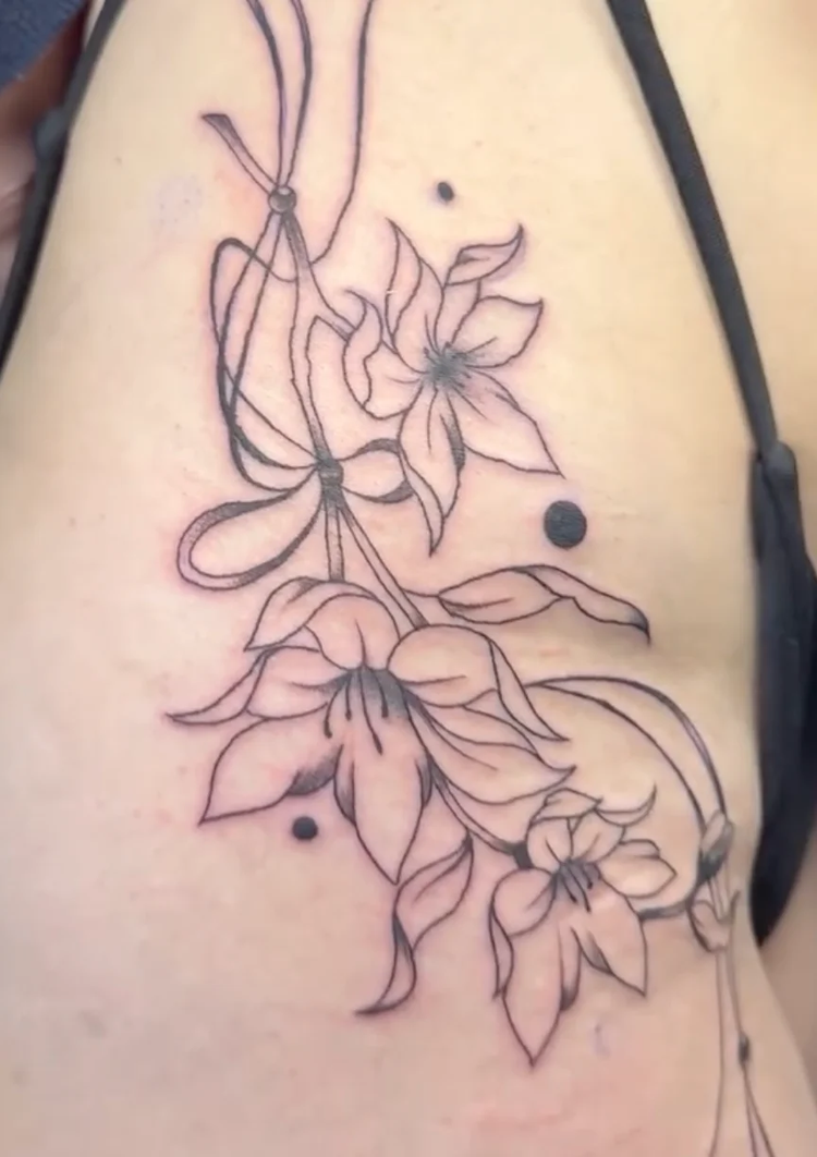 Delicate floral line work tattoo