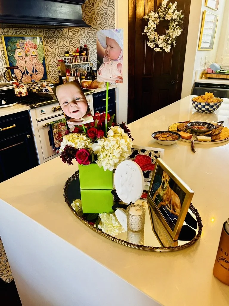 first birthday floral arrangement with baby photos