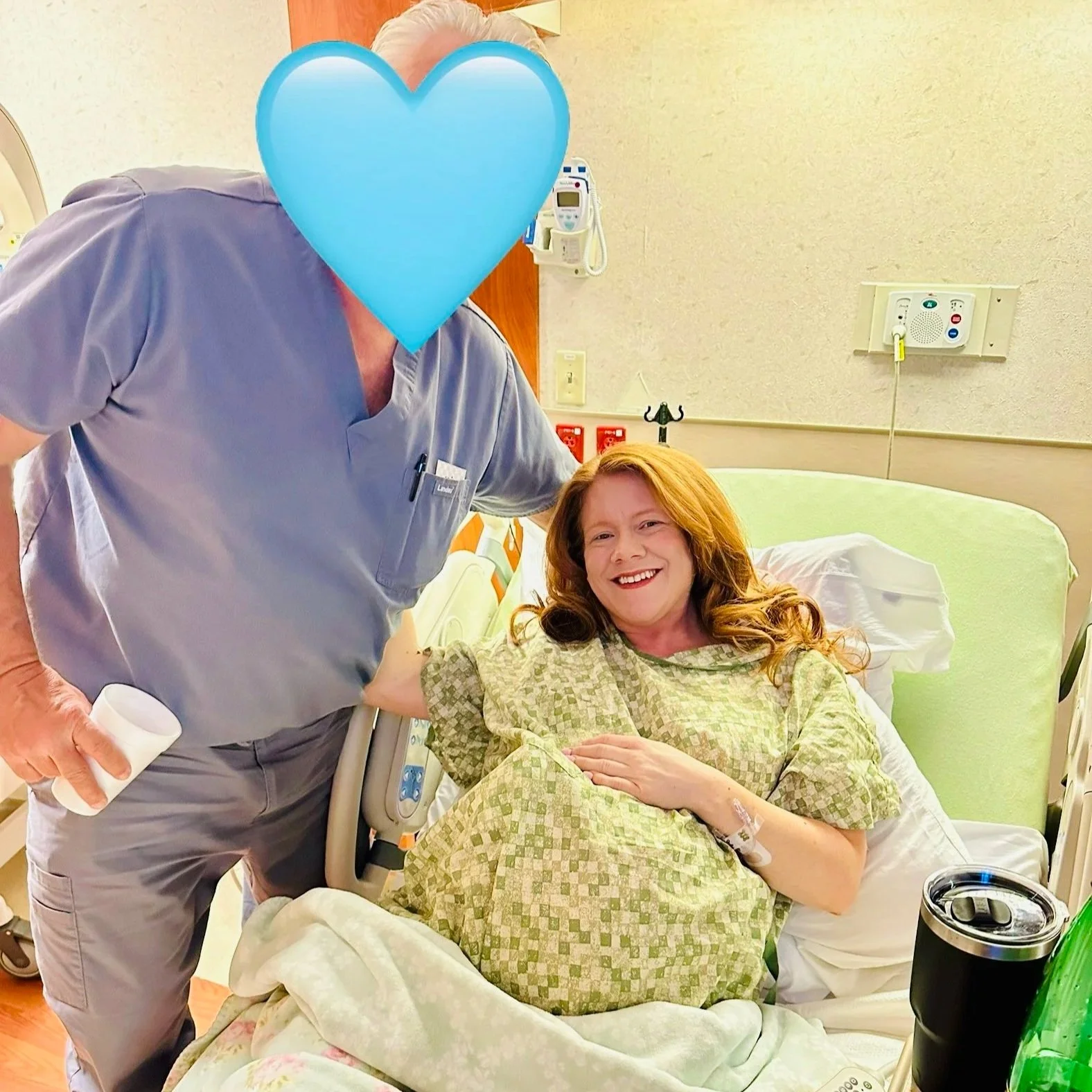 New mother in hospital bed with supportive father after childbirth during postpartum recovery journey.