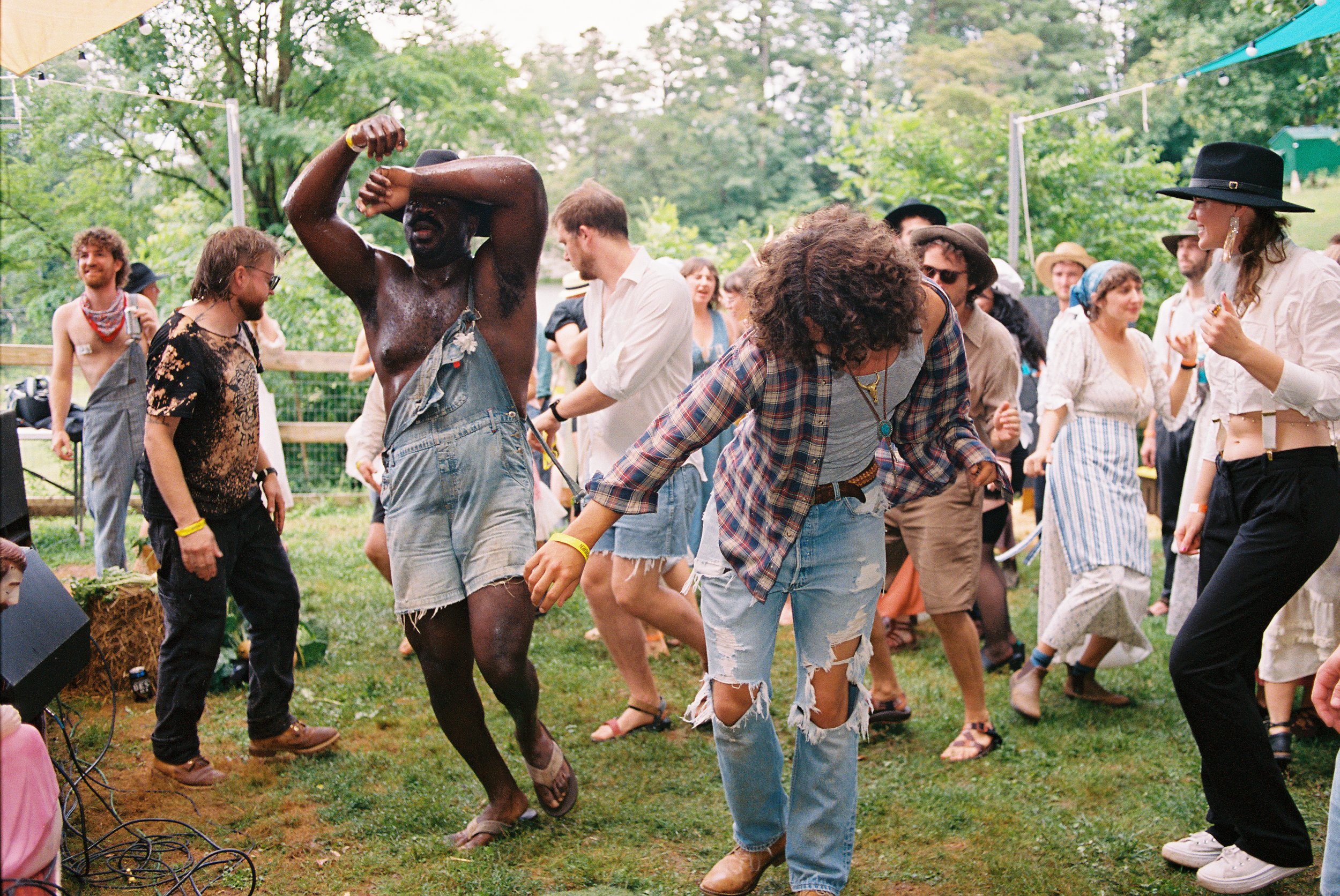 Crowd dancing and laughing to lively music at Churning Man music and arts camping festival near Asheville, North Carolina