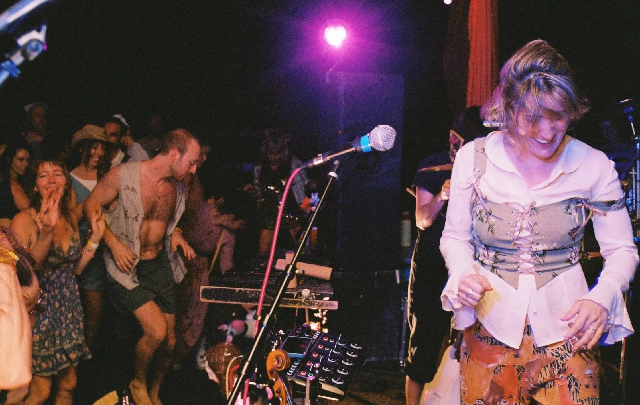 Festivalgoers dancing to nationally-touring band, Animal Prince, in front of a live music stage at Churning Man, Western North Carolina camping festival