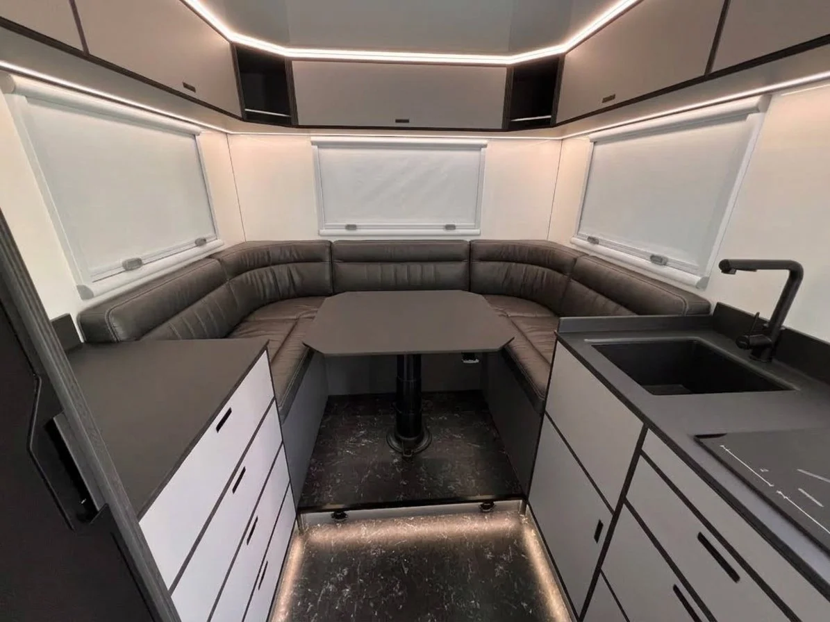 U-shaped lounge with grey leather upholstery inside the habitat box
