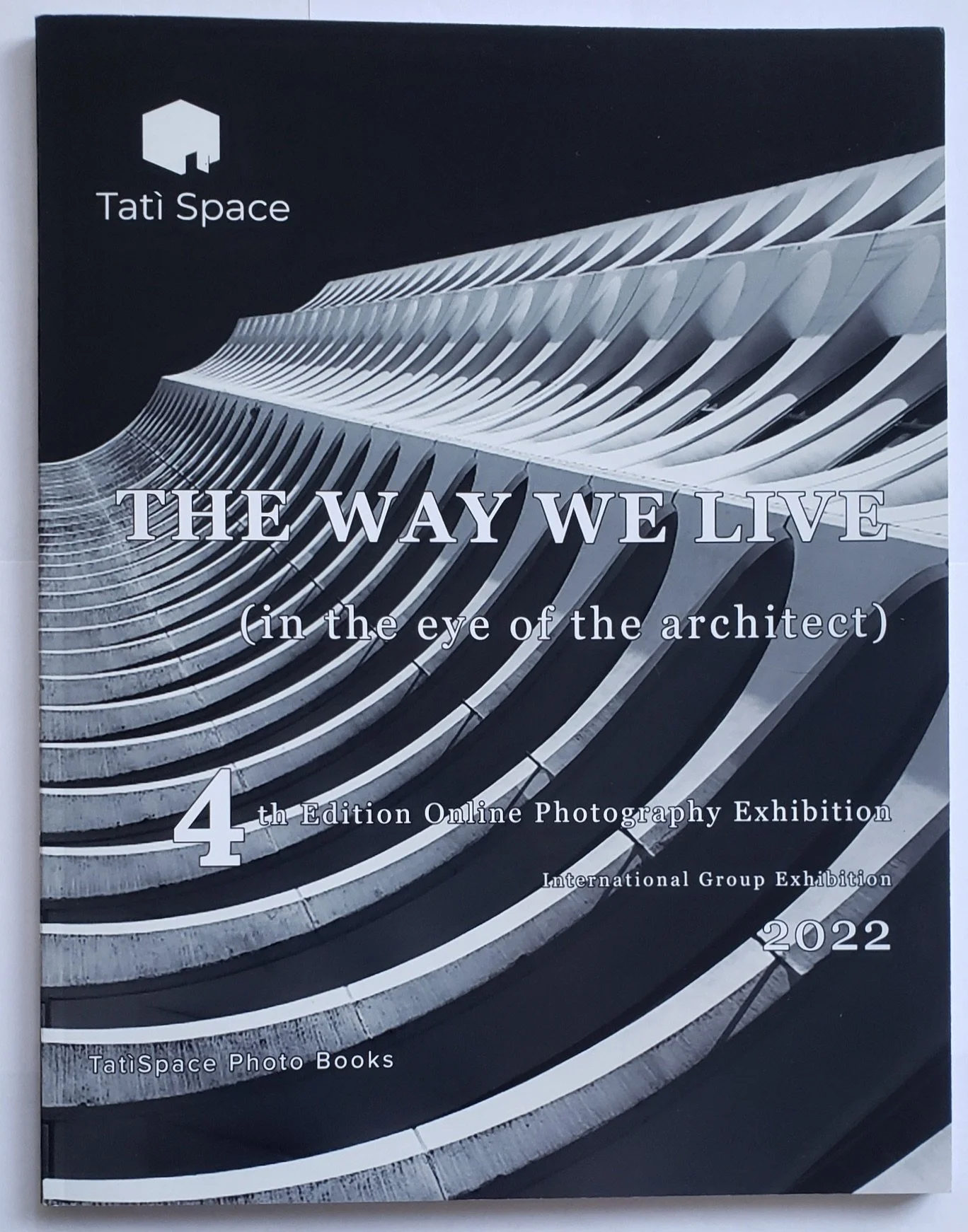 Cover of a book titled "The Way We Live (in the eye of the architect)" with a black and white architectural photograph of a modern building with curved, layered design.