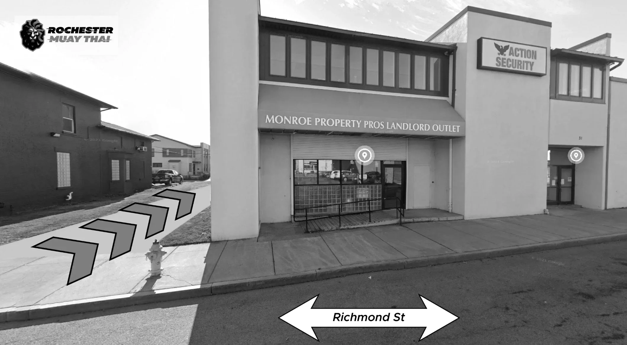 A commercial building on Richmond Street with signs for Monroe Property Pros Landlord Outlet and Action Security. The building has large windows, a metal security shutter, and a sidewalk in front. There are parked cars in the background and a fire hydrant near the curb. Chevron arrows on the sidewalk indicate a path, and there are logos for Rochester Muay Thai in the top left corner.
