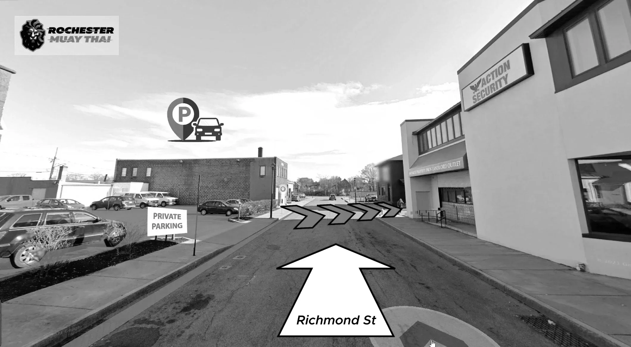 Street view showing Richmond Street with arrows indicating a right turn, parking lot with cars, a sign for private parking, buildings including a security action business, and a logo for Rochester Muay Thai in the top left corner.
