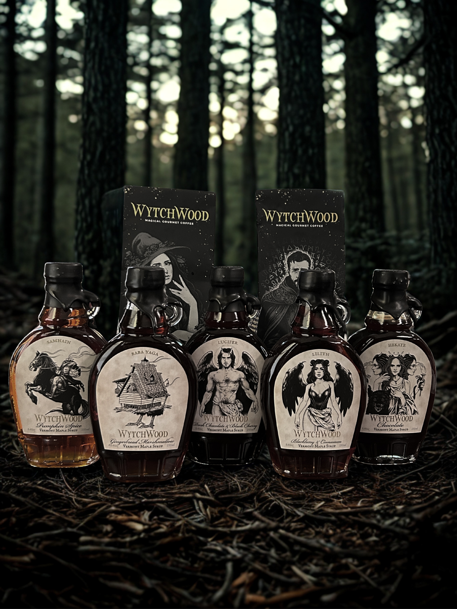Collection of five syrup bottles with themed labels resembling witches, demons, and fantasy characters, placed on forest floor with trees in background.