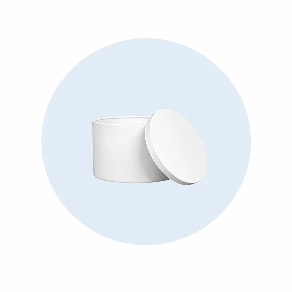 A white, round cosmetic jar with its lid placed beside it on a light blue circular background.