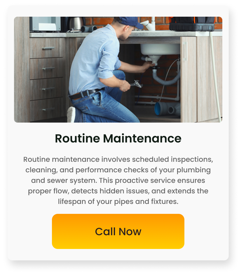 A man kneeling under a kitchen sink, repairing plumbing pipes, with kitchen cabinets and appliances visible above.