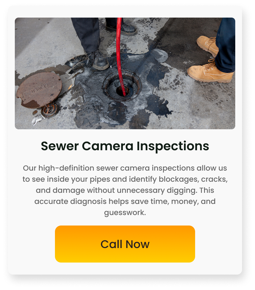 Workers inspecting a sewer opening with cameras in a city street.