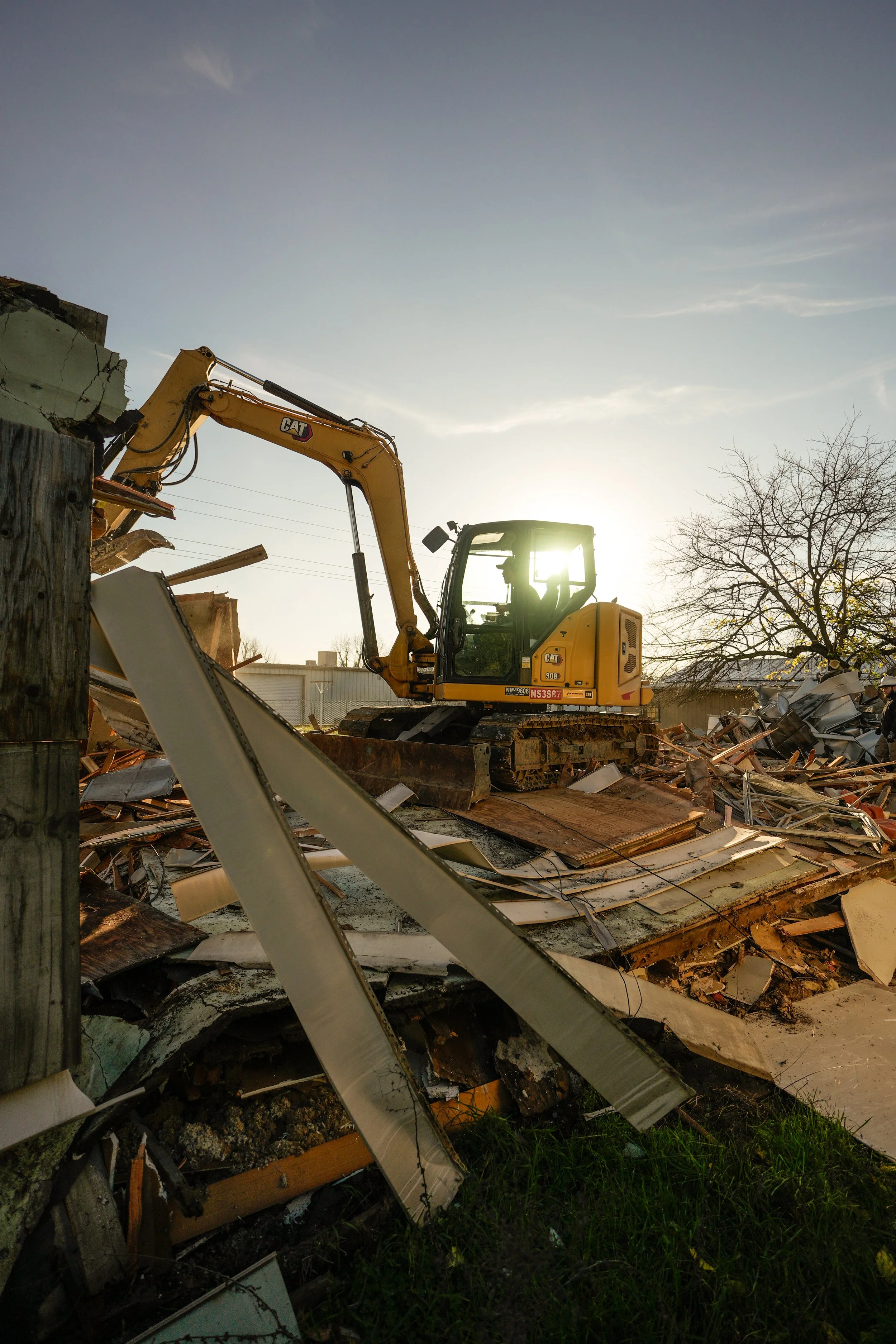 Residential demolition project using excavator and crew in Redding California