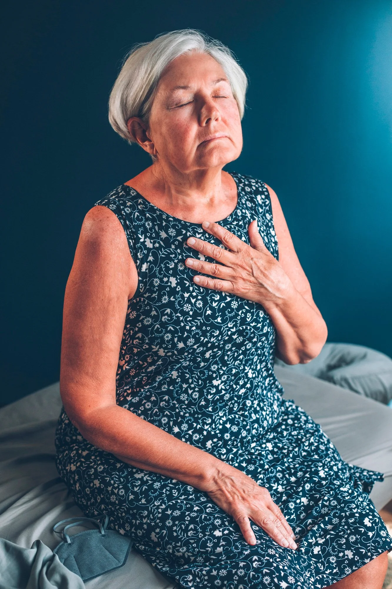 Female patient meditating on a treatment table after acupuncture session.