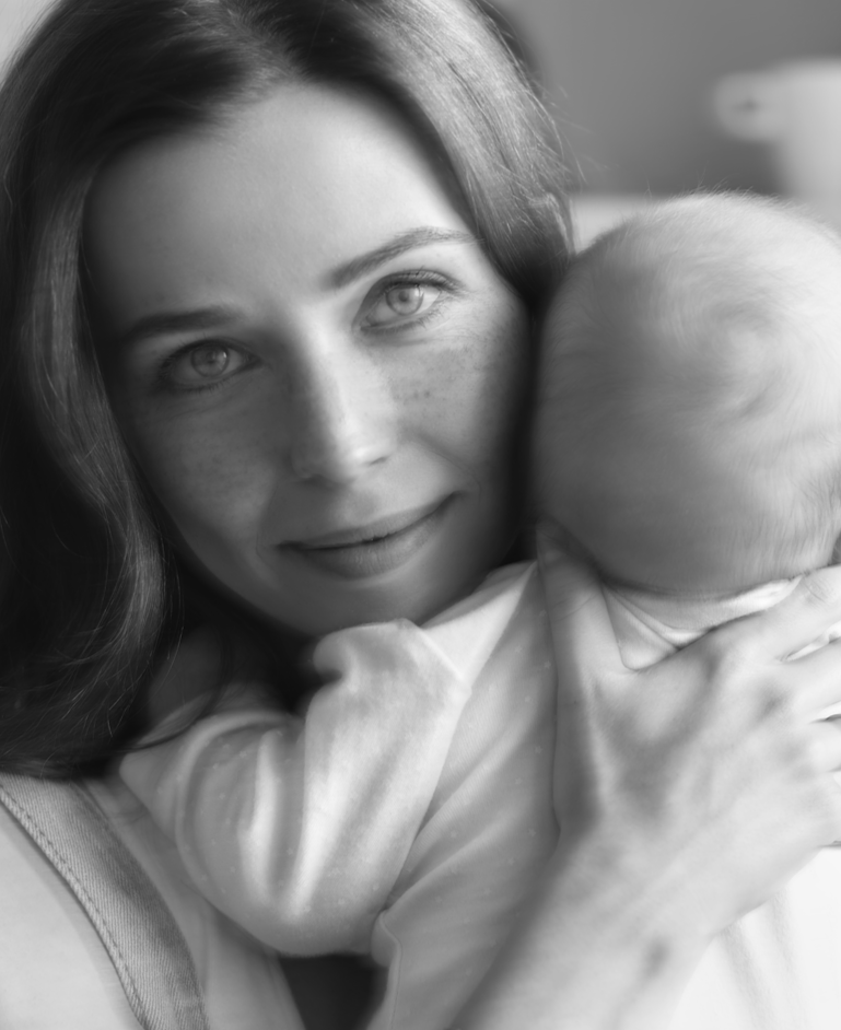A mother cradling her baby, brand photography for Rachael Benjamin Therapy.