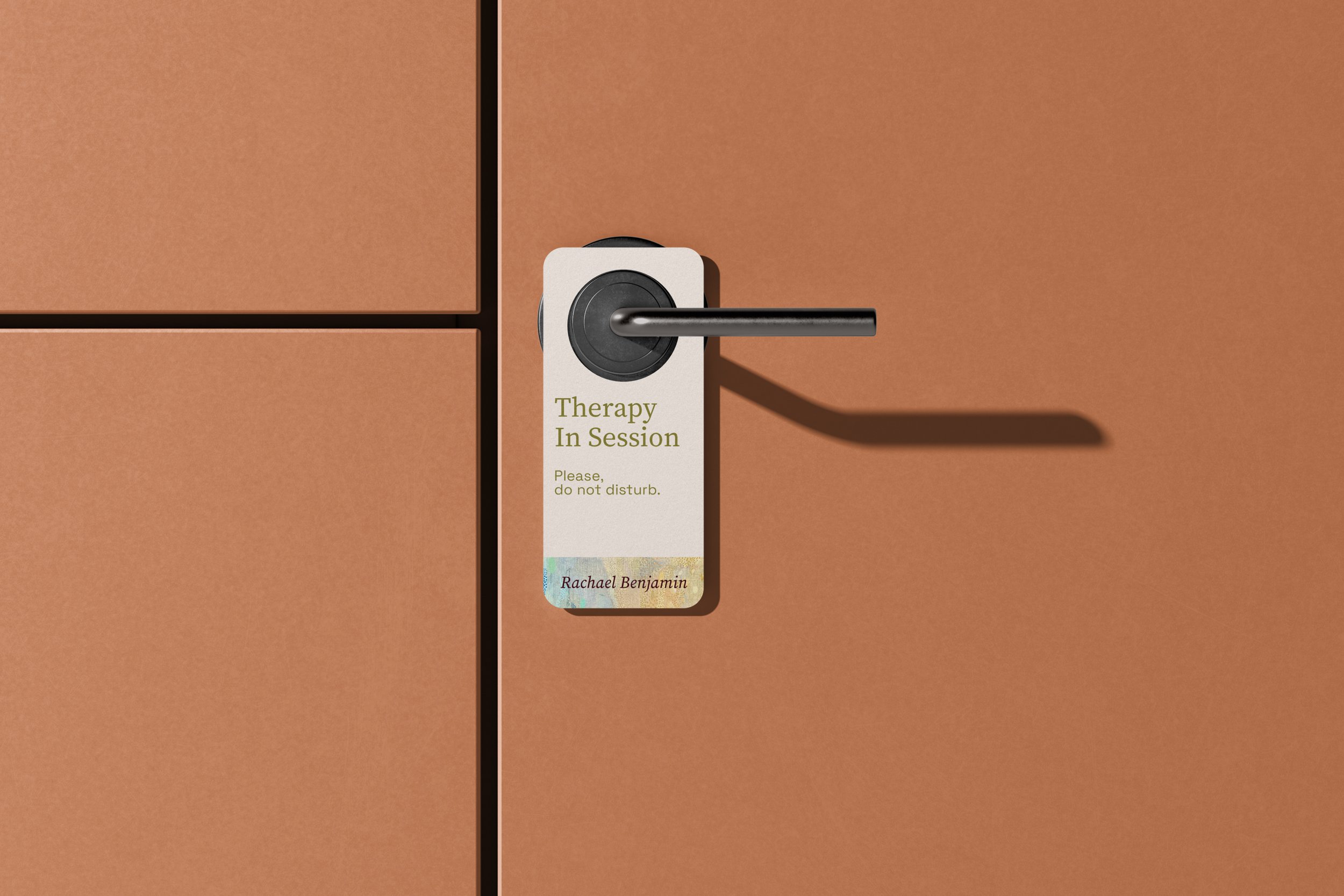 Branded privacy doorknob hanger mockup for Rachael Benjamin Therapy private practice.