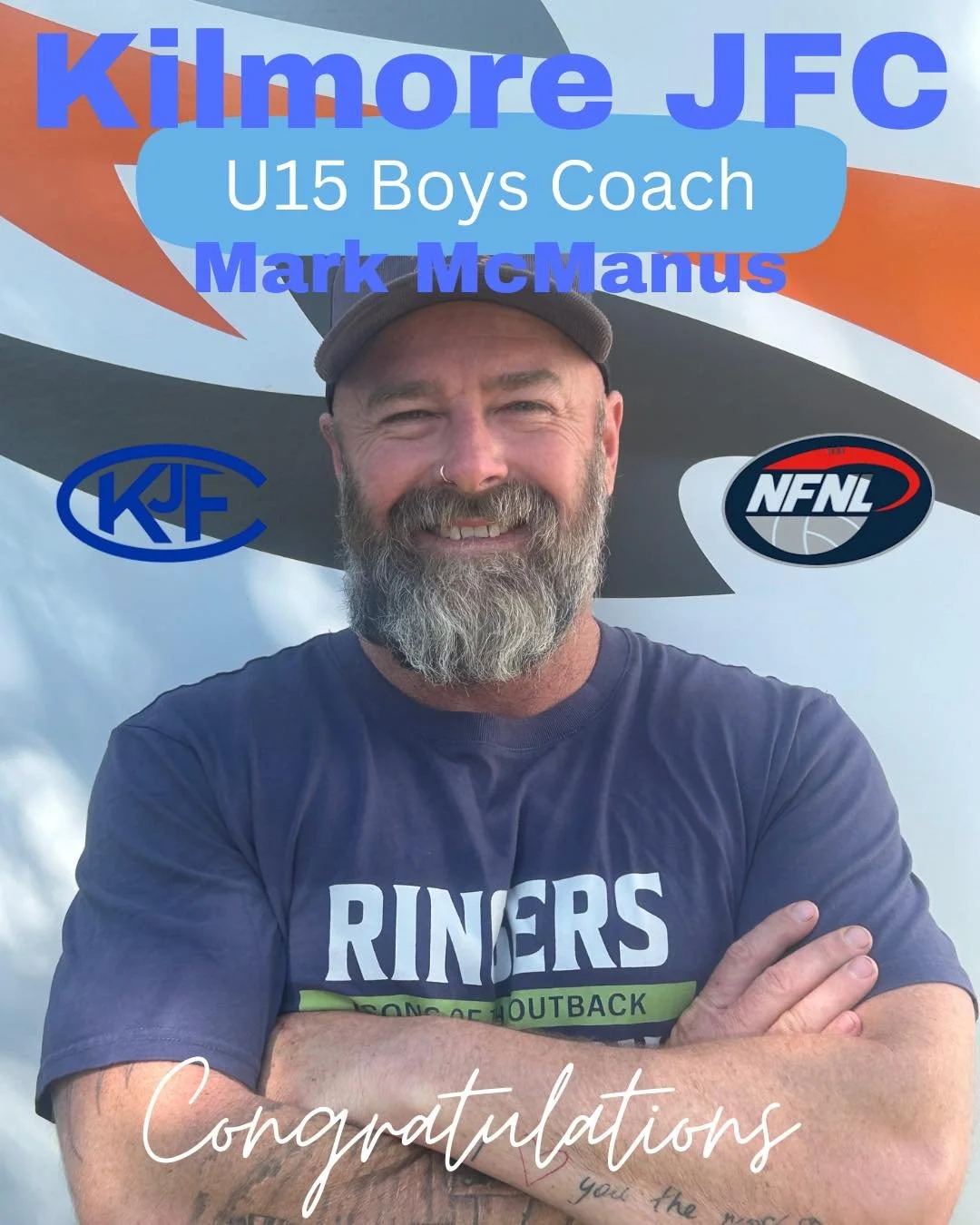 A bearded man wearing a baseball cap and a Ringers Outback shirt, smiling with arms crossed. The background displays a logo for Kilmore JFC, an NFNL logo, and a blue banner with text indicating his role as U15 Boys Coach Mark McManus, with a congratulatory message.