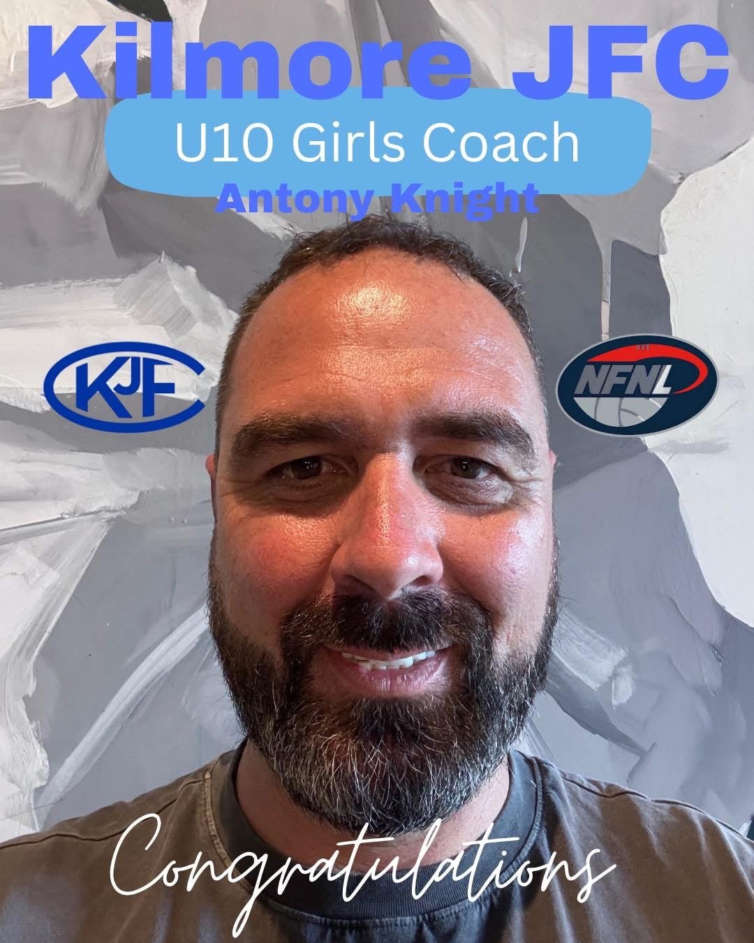 A man with a beard and short hair smiling in front of a gray abstract background, with the logos of KJFL and NFL. Text overlay celebrates him as the U10 Girls Coach for Kilmore-JFC, named Antony Knight.