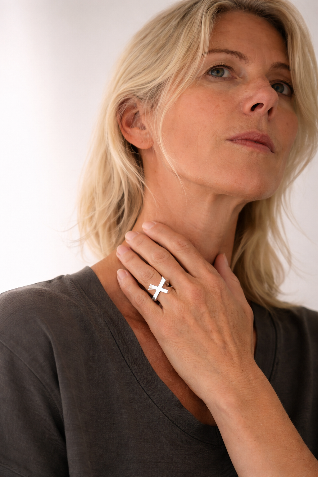 Sleek cross ring and soft elegance.png